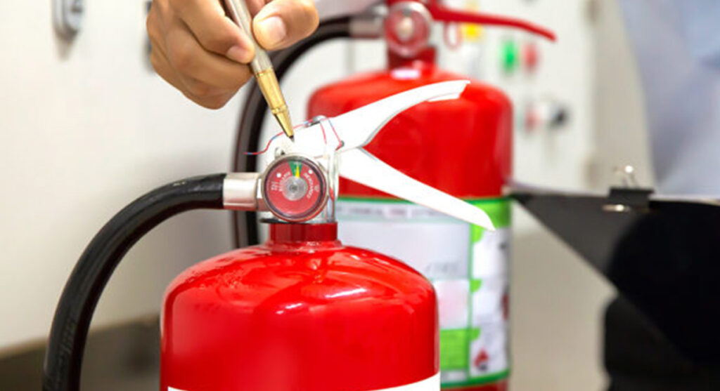 expert performing inspection on a fire extinguisher